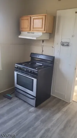 a stove top oven sitting inside of a kitchen