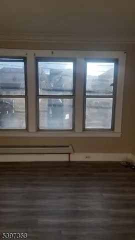 a view of wooden floor and windows in a room