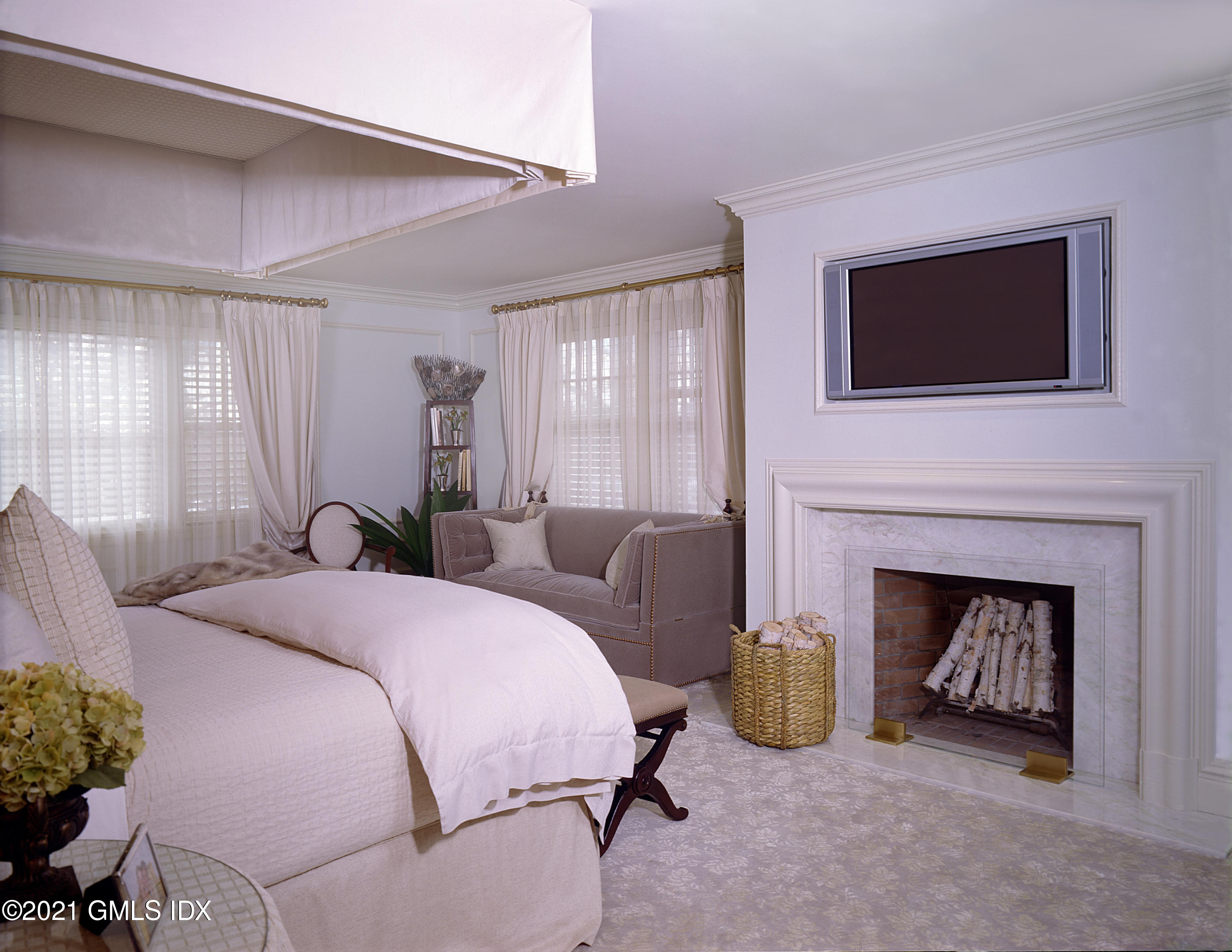 200 Byram Shore Road Greenwich, CT 06830 - Photo 17 of 27 a bedroom with bed and a fireplace