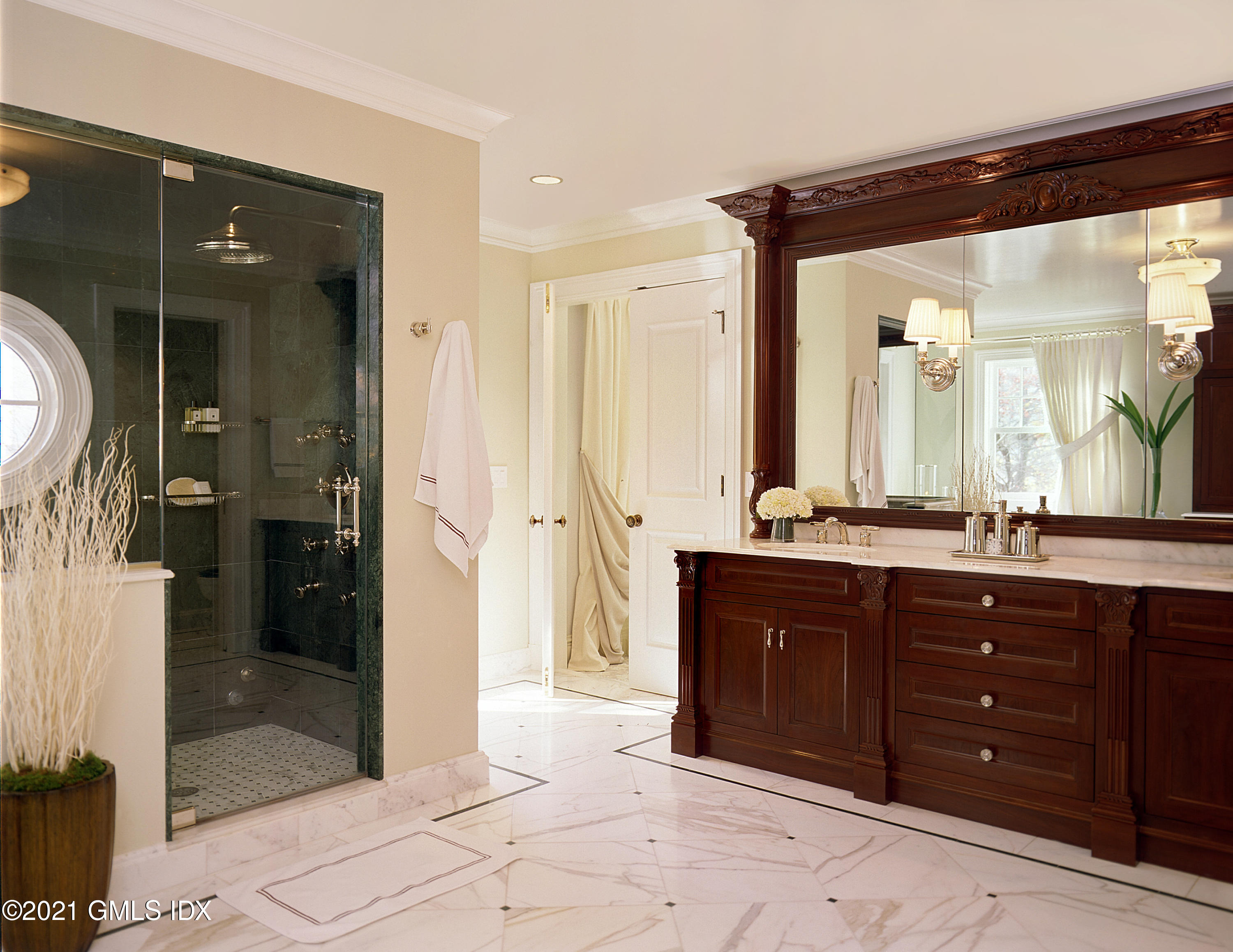 200 Byram Shore Road Greenwich, CT 06830 - Photo 18 of 27 a bath room with a sink and a mirror