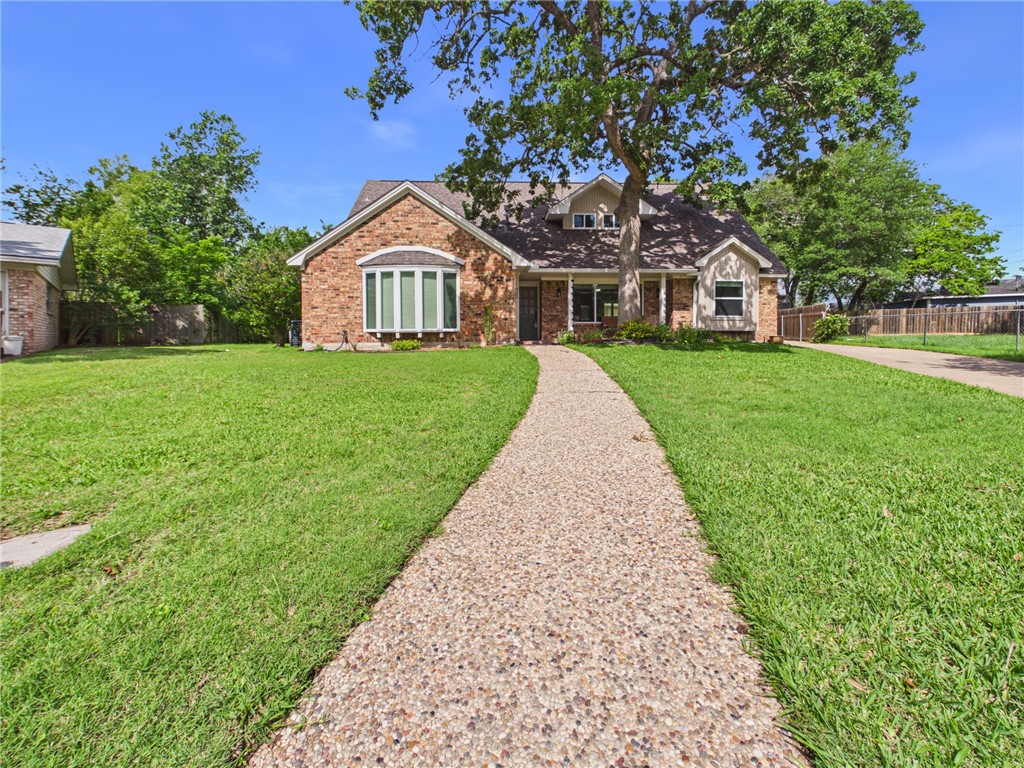 902 Briar Bend Court Bryan, TX 77802 - Photo 1 of 39 a front view of a house with a yard