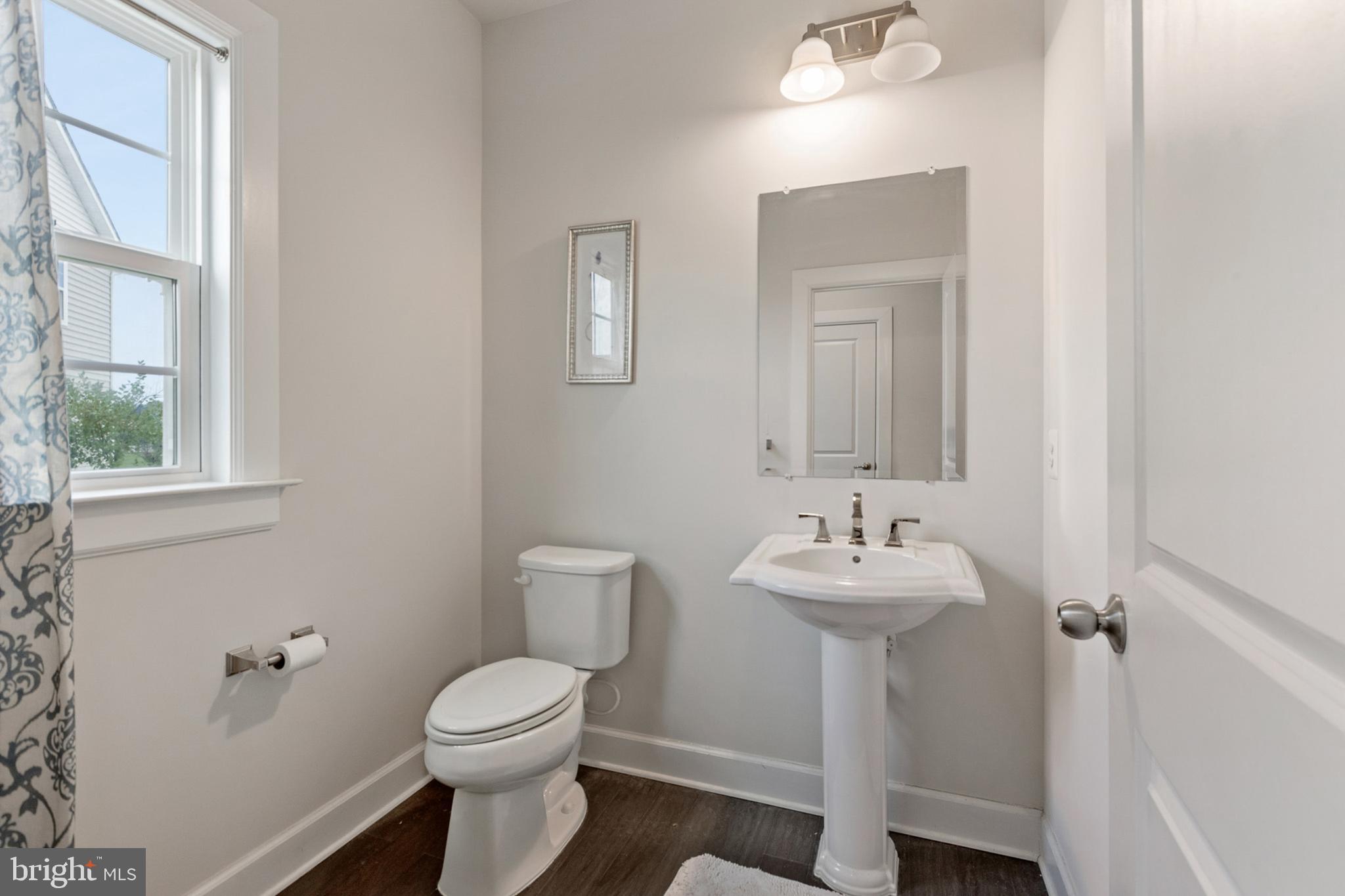 4300 Open Field Court Bowie, MD 20720 - Photo 15 of 53 a bathroom with a sink mirror and toilet