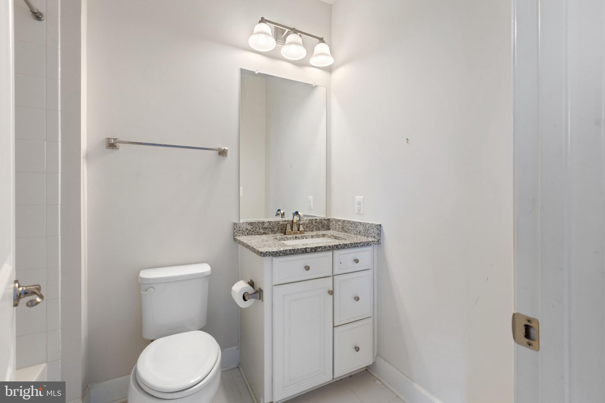 4300 Open Field Court Bowie, MD 20720 - Photo 20 of 53 a bathroom with a granite countertop toilet sink and mirror