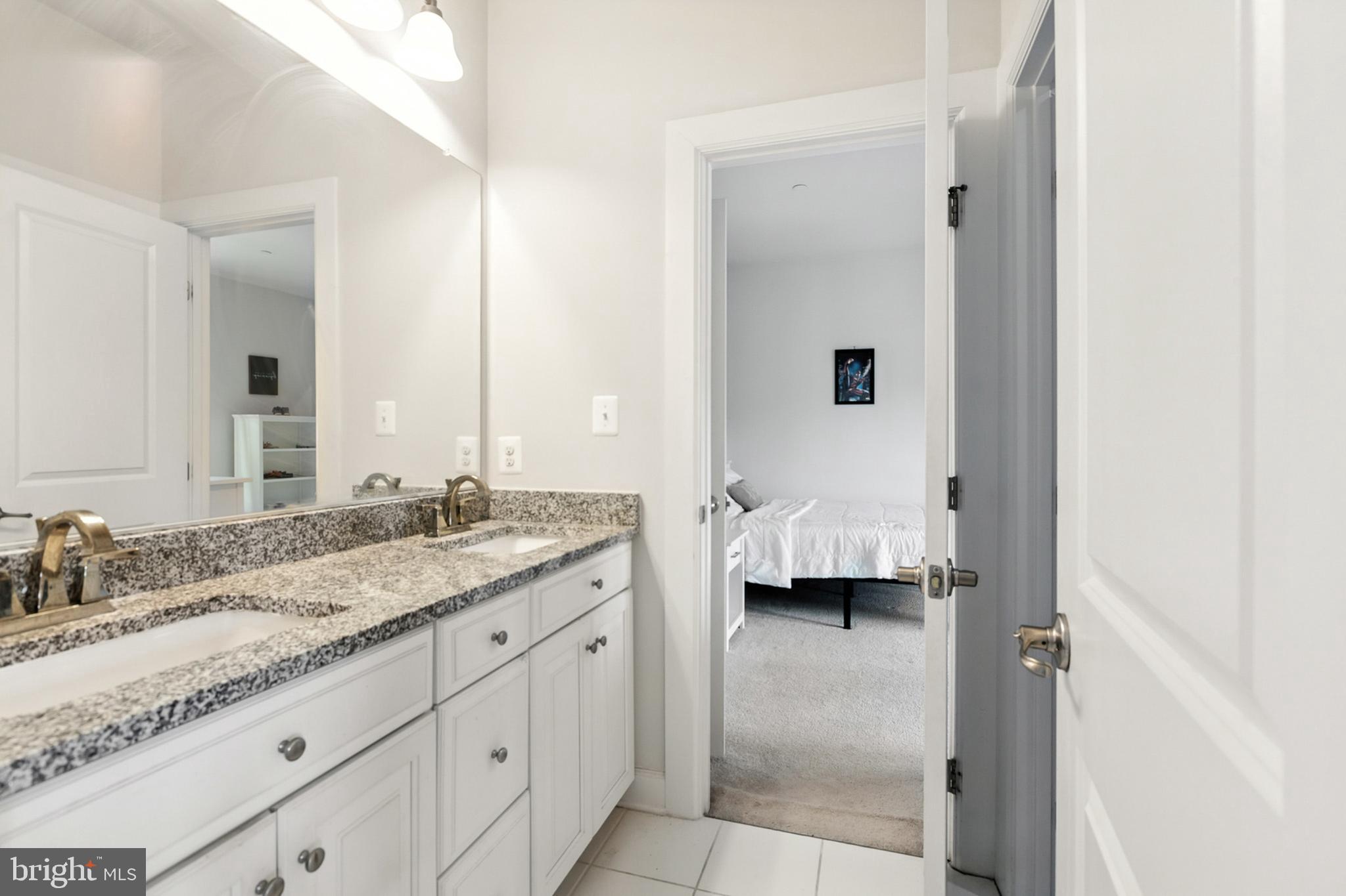 4300 Open Field Court Bowie, MD 20720 - Photo 23 of 53 a en suite bathroom with a granite countertop sink and a mirror