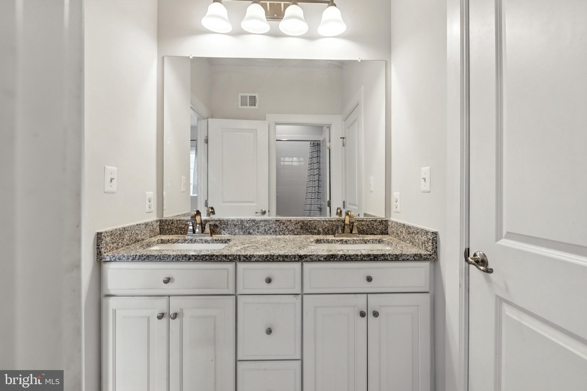 4300 Open Field Court Bowie, MD 20720 - Photo 24 of 53 a bathroom with a granite countertop sink and a mirror