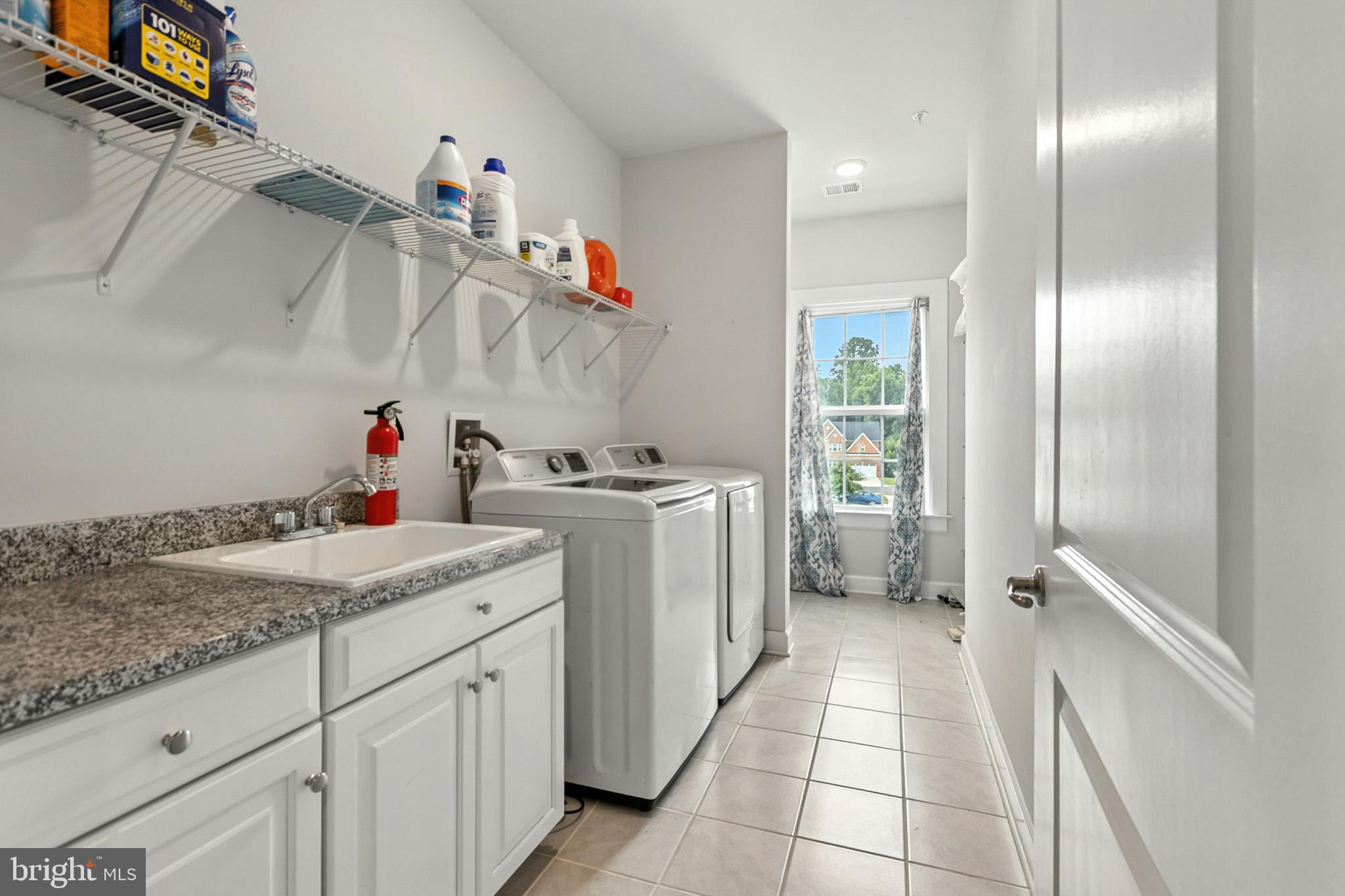 4300 Open Field Court Bowie, MD 20720 - Photo 28 of 53 a utility room with cabinets washer and dryer