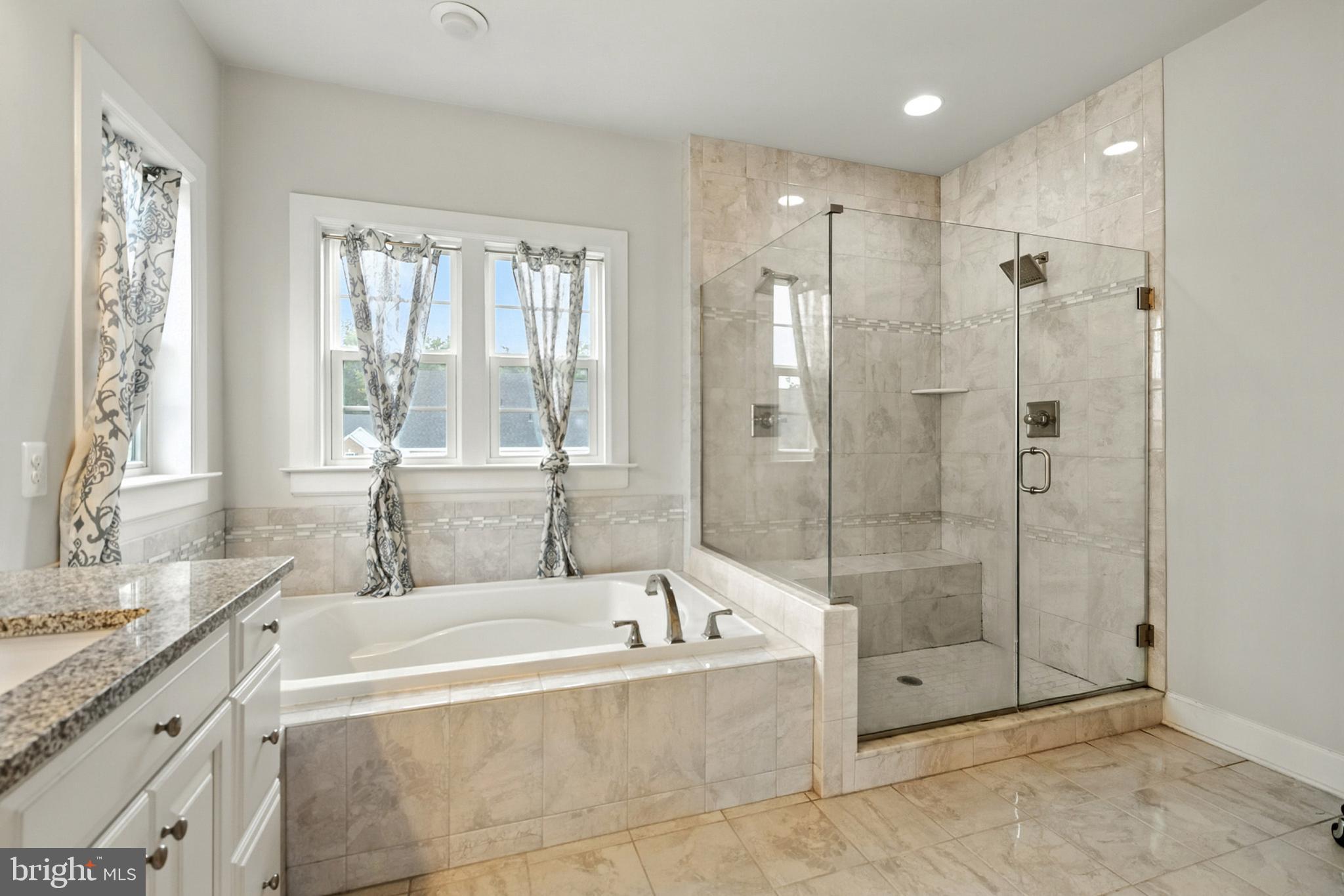 4300 Open Field Court Bowie, MD 20720 - Photo 33 of 53 a spacious bathroom with a granite countertop tub shower and sink