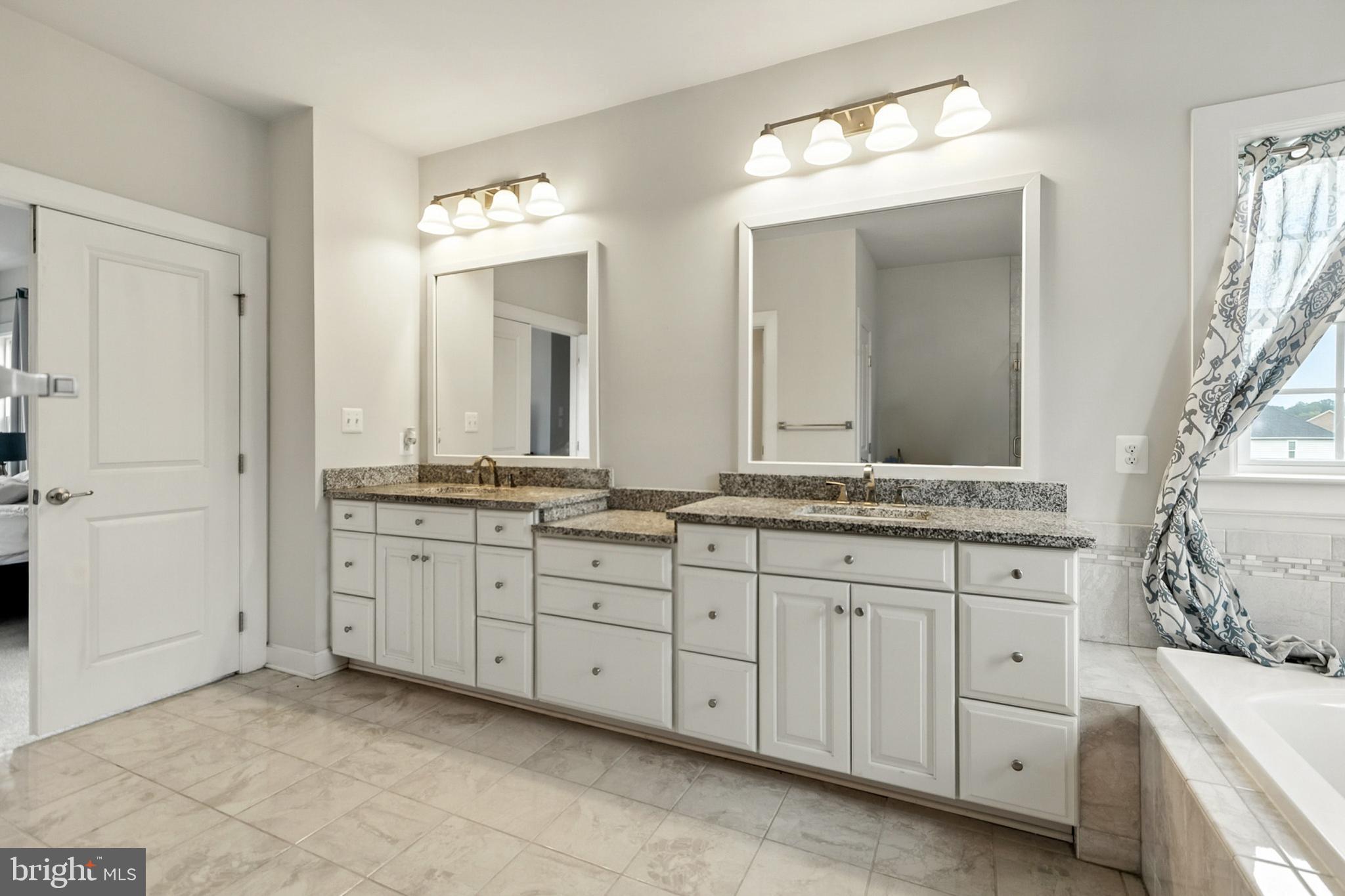 4300 Open Field Court Bowie, MD 20720 - Photo 34 of 53 a spacious bathroom with double sink and a mirror