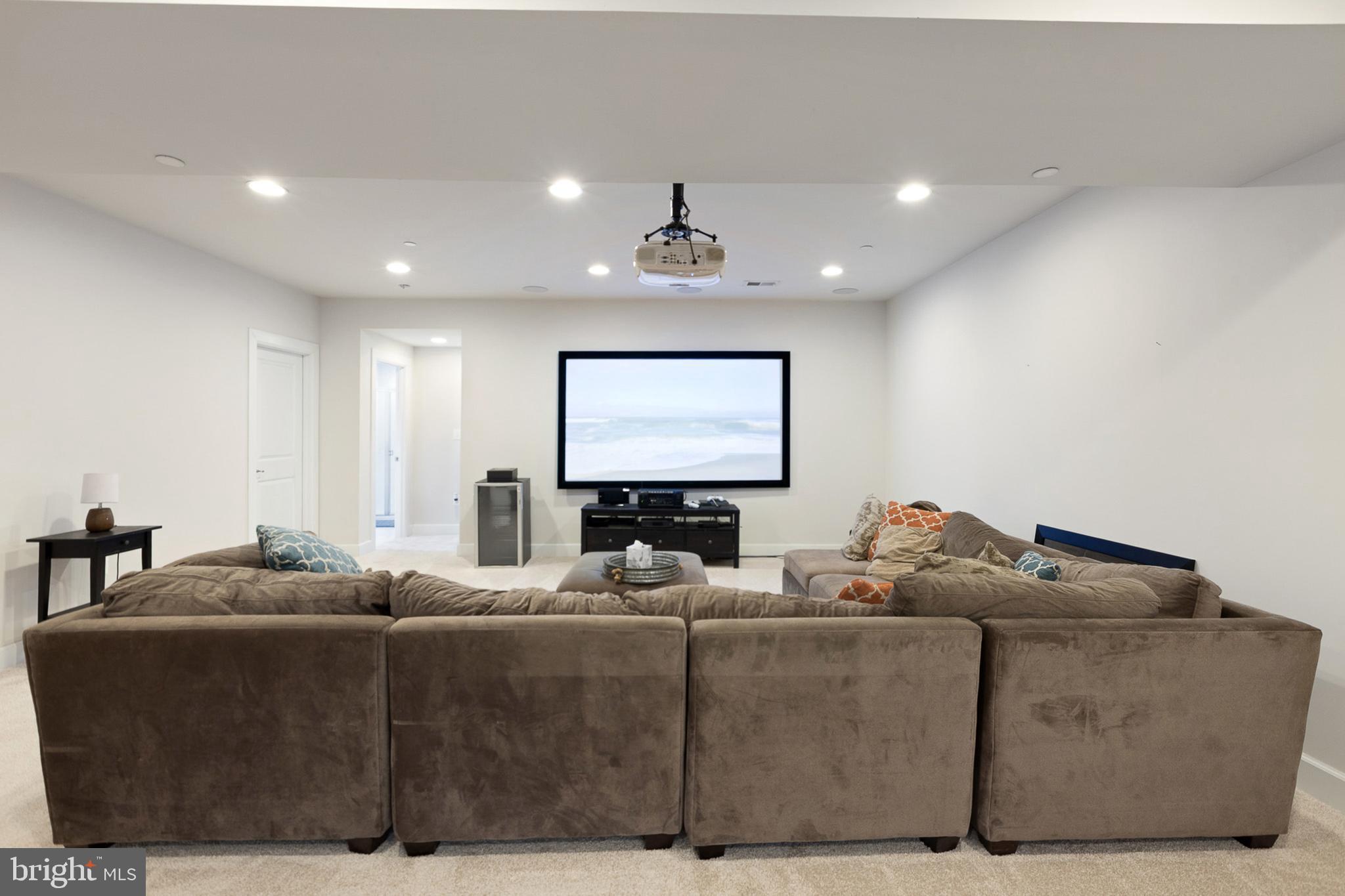 4300 Open Field Court Bowie, MD 20720 - Photo 37 of 53 a living room with furniture a large window and a projector