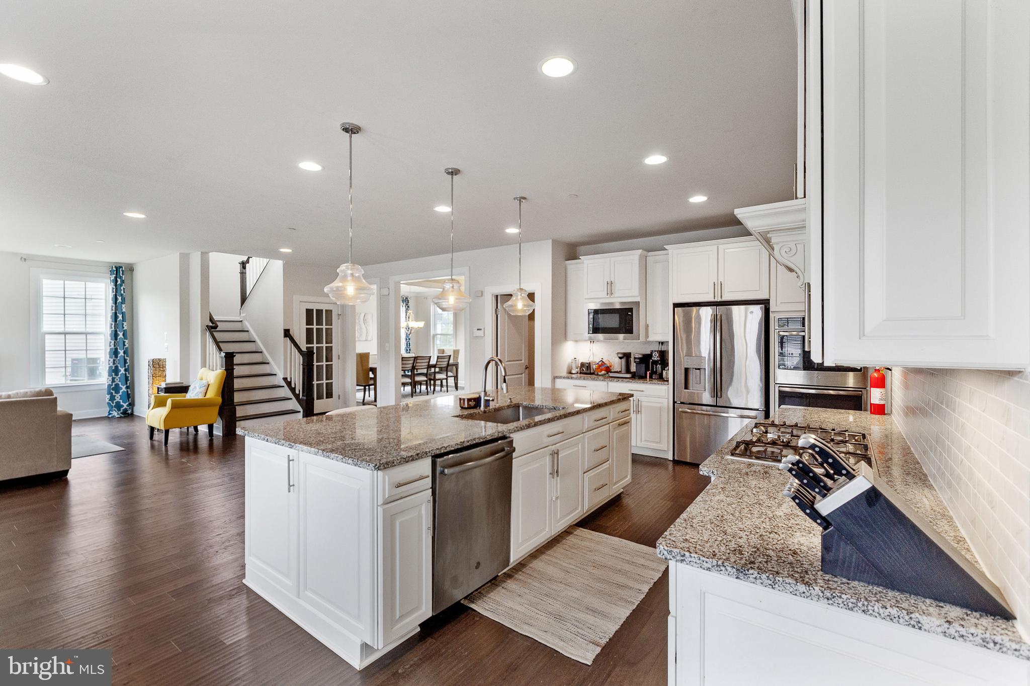 4300 Open Field Court Bowie, MD 20720 - Photo 6 of 53 a kitchen with stainless steel appliances granite countertop a refrigerator oven a sink a stove and white cabinets