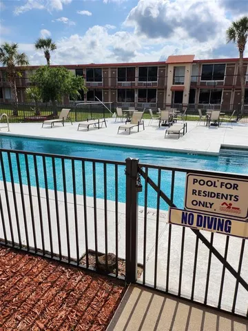 swimming pool view with sitting space and garden view