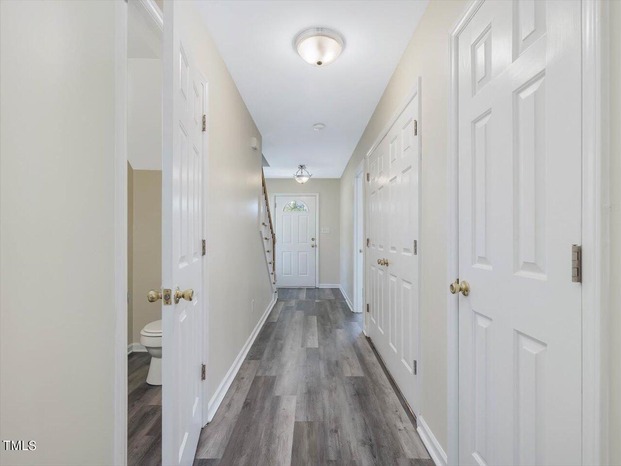 2907 Dearborn Drive Durham, NC 27704 - Photo 11 of 52 a view of a hallway with wooden floor and a bathroom