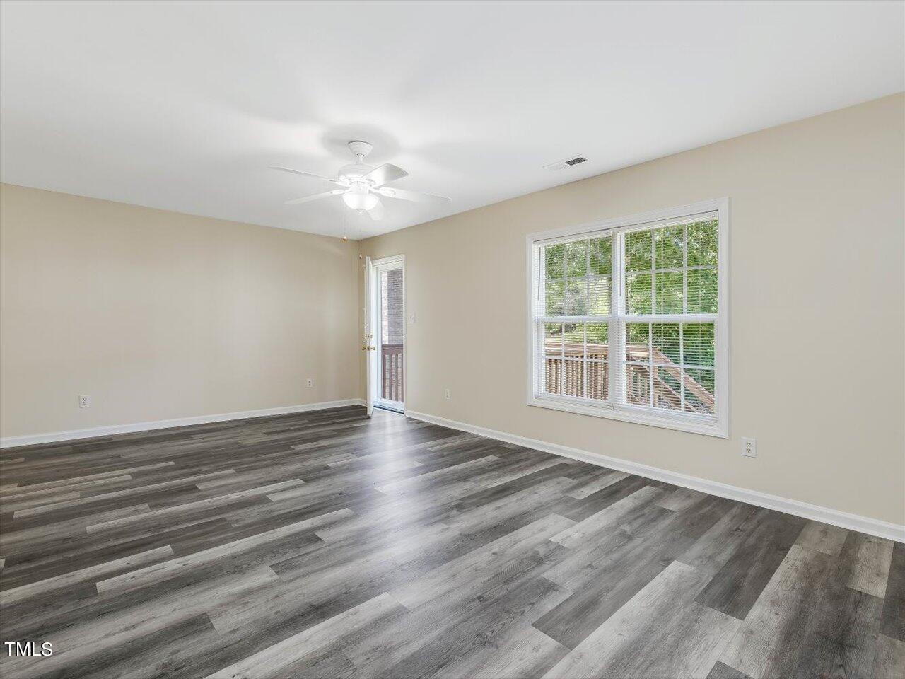 2907 Dearborn Drive Durham, NC 27704 - Photo 13 of 52 a view of an empty room with wooden floor and a window