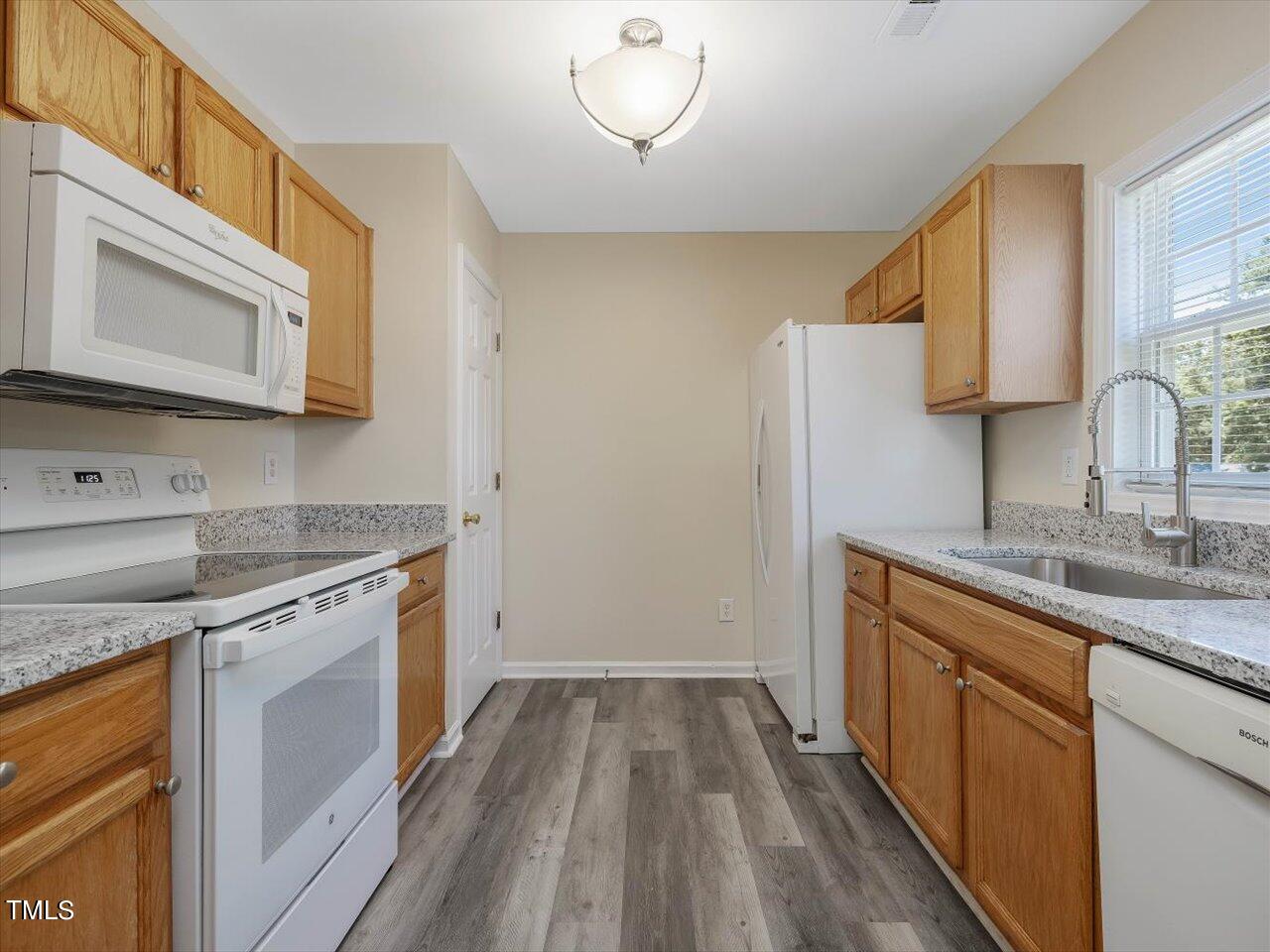 2907 Dearborn Drive Durham, NC 27704 - Photo 17 of 52 a kitchen with a sink stove and cabinets