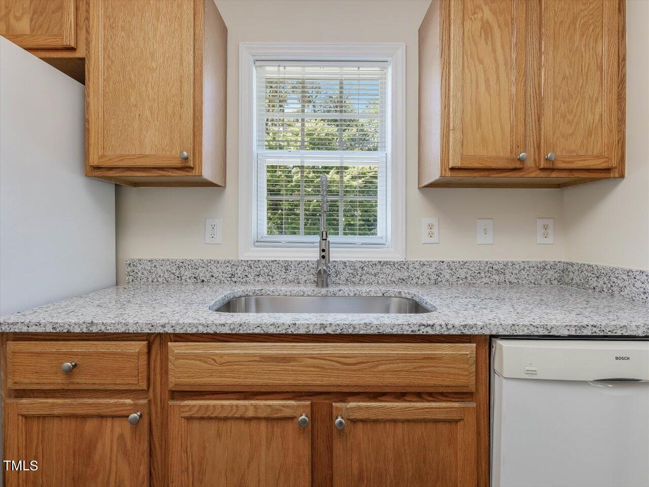 2907 Dearborn Drive Durham, NC 27704 - Photo 19 of 52 a kitchen with granite countertop stainless steel appliances white cabinets and a sink