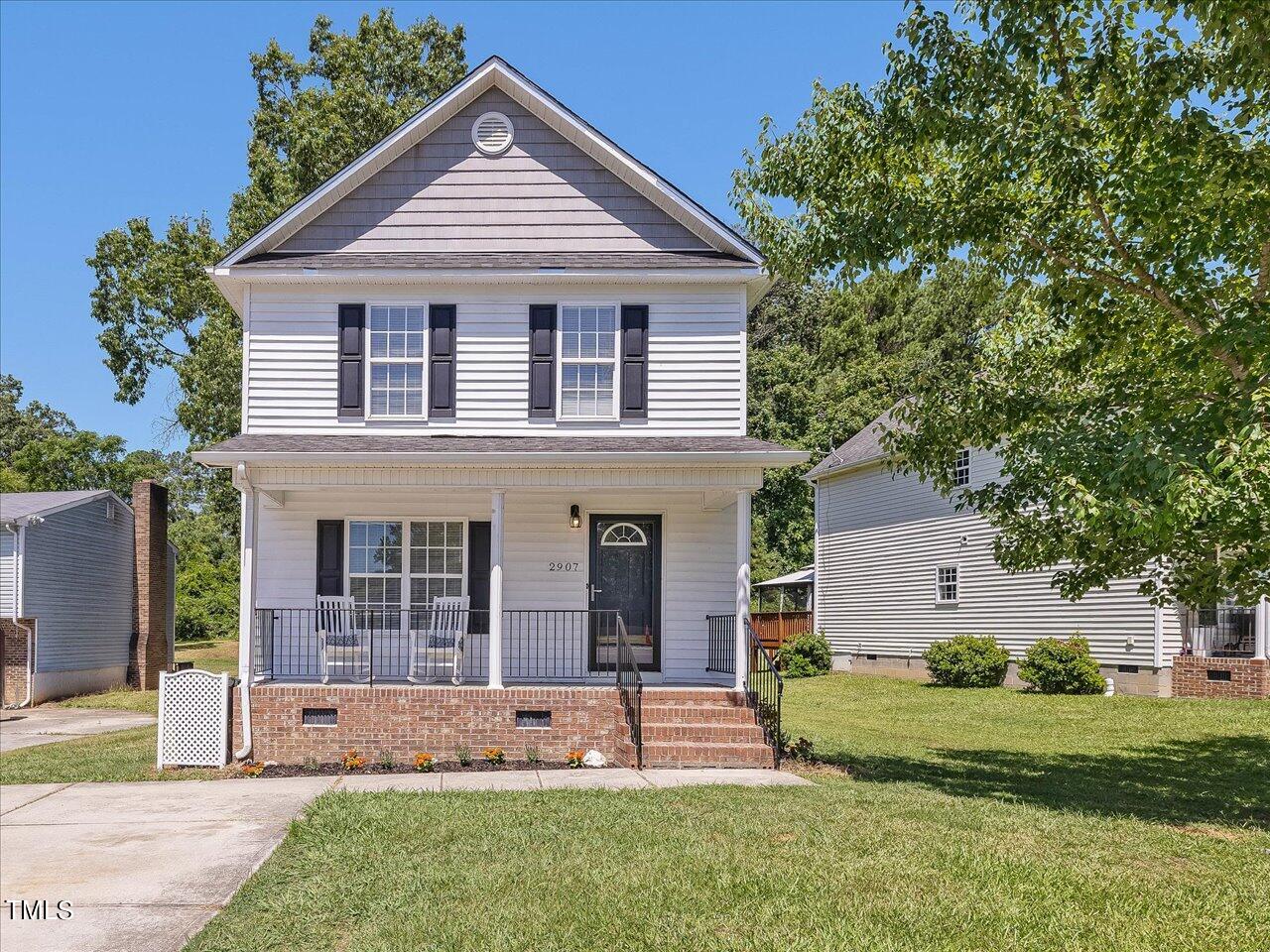 2907 Dearborn Drive Durham, NC 27704 - Photo 2 of 52 a front view of a house with a yard and garage