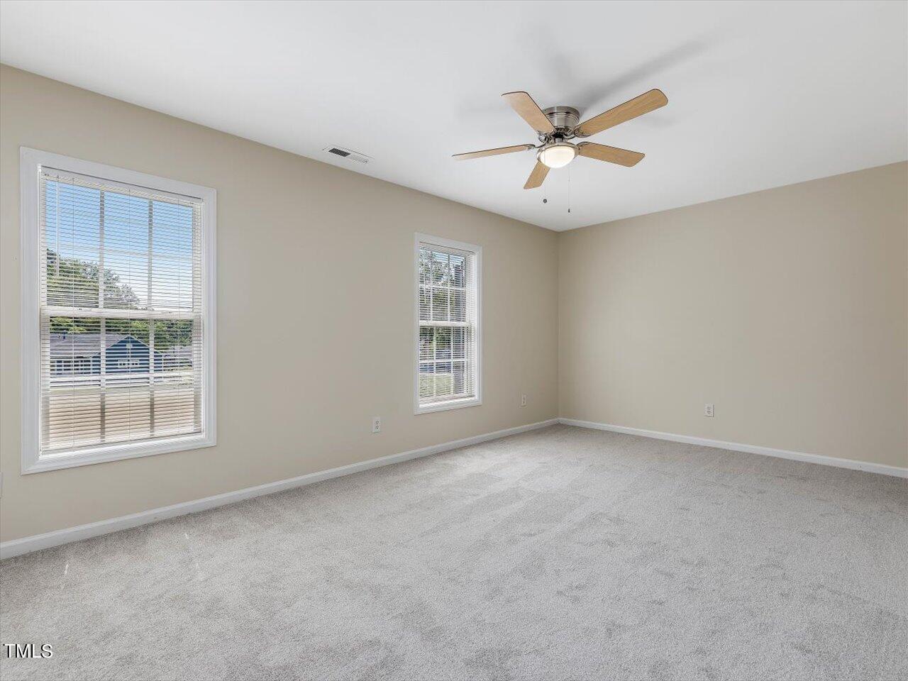 2907 Dearborn Drive Durham, NC 27704 - Photo 33 of 52 an empty room with windows and fan