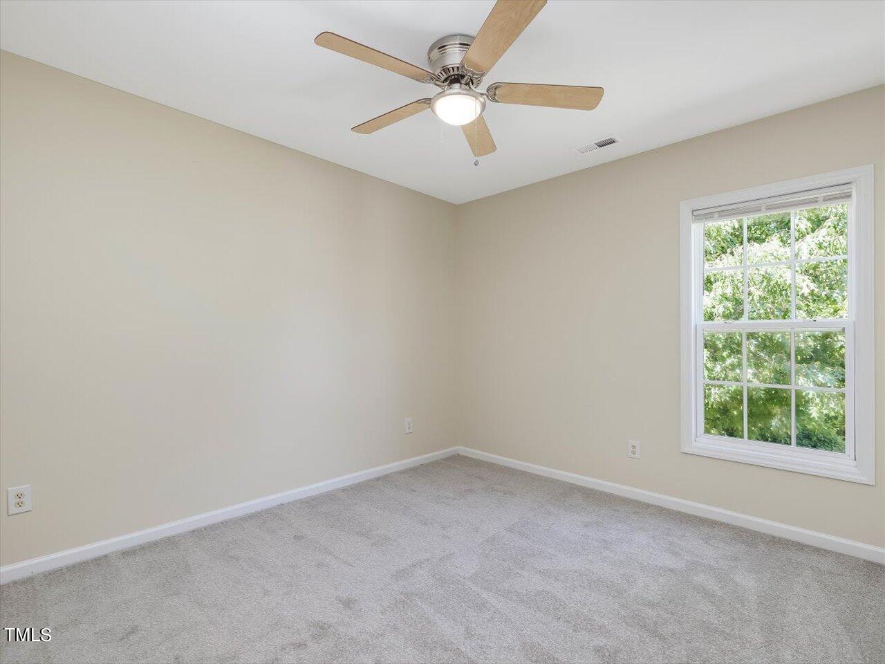 2907 Dearborn Drive Durham, NC 27704 - Photo 38 of 52 an empty room with a window and a fan