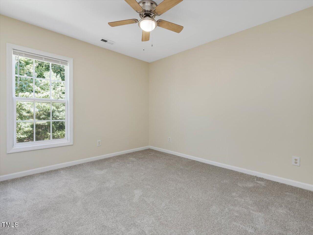 2907 Dearborn Drive Durham, NC 27704 - Photo 41 of 52 an empty room with a window and a fan