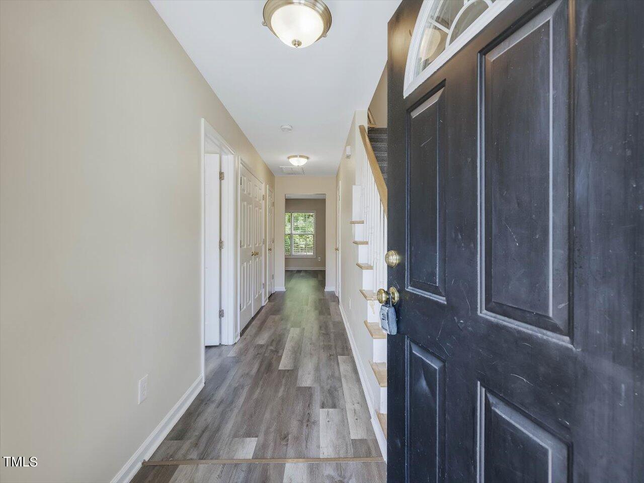 2907 Dearborn Drive Durham, NC 27704 - Photo 7 of 52 a view of a hallway with wooden floor and staircase