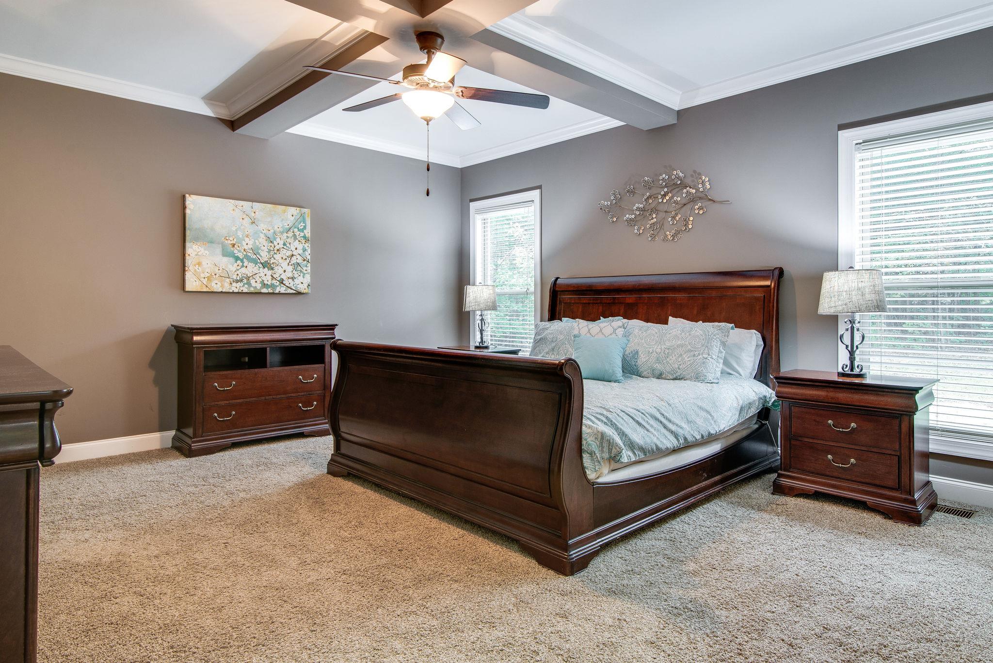 737 Harkreader Road Mount Juliet, TN 37122 - Photo 10 of 26 a bedroom with a bed and a chandelier