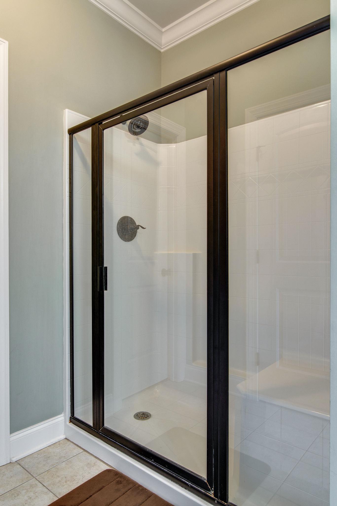 737 Harkreader Road Mount Juliet, TN 37122 - Photo 12 of 26 a bathroom with a glass shower door