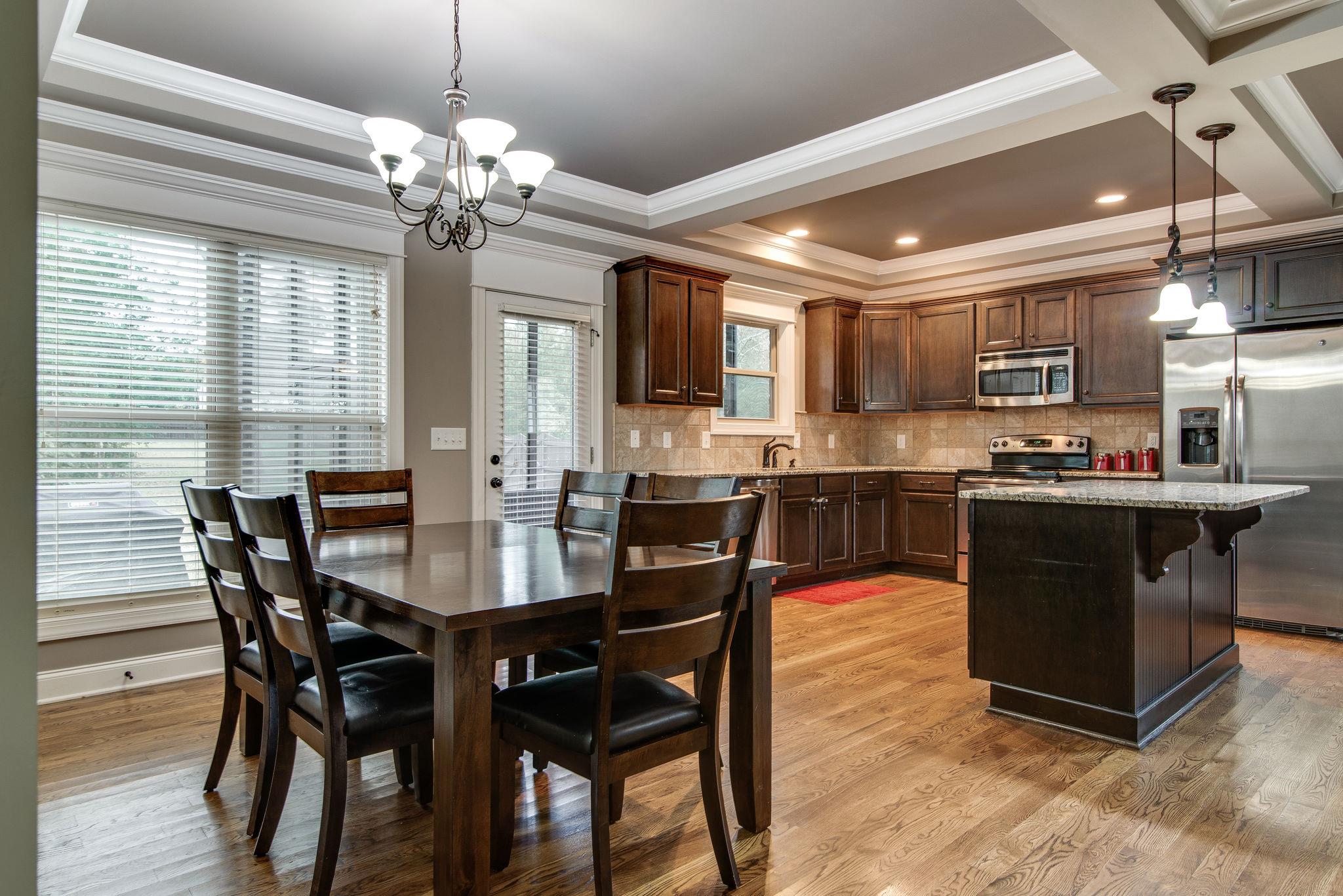737 Harkreader Road Mount Juliet, TN 37122 - Photo 26 of 26 a kitchen with kitchen island a dining table and chairs