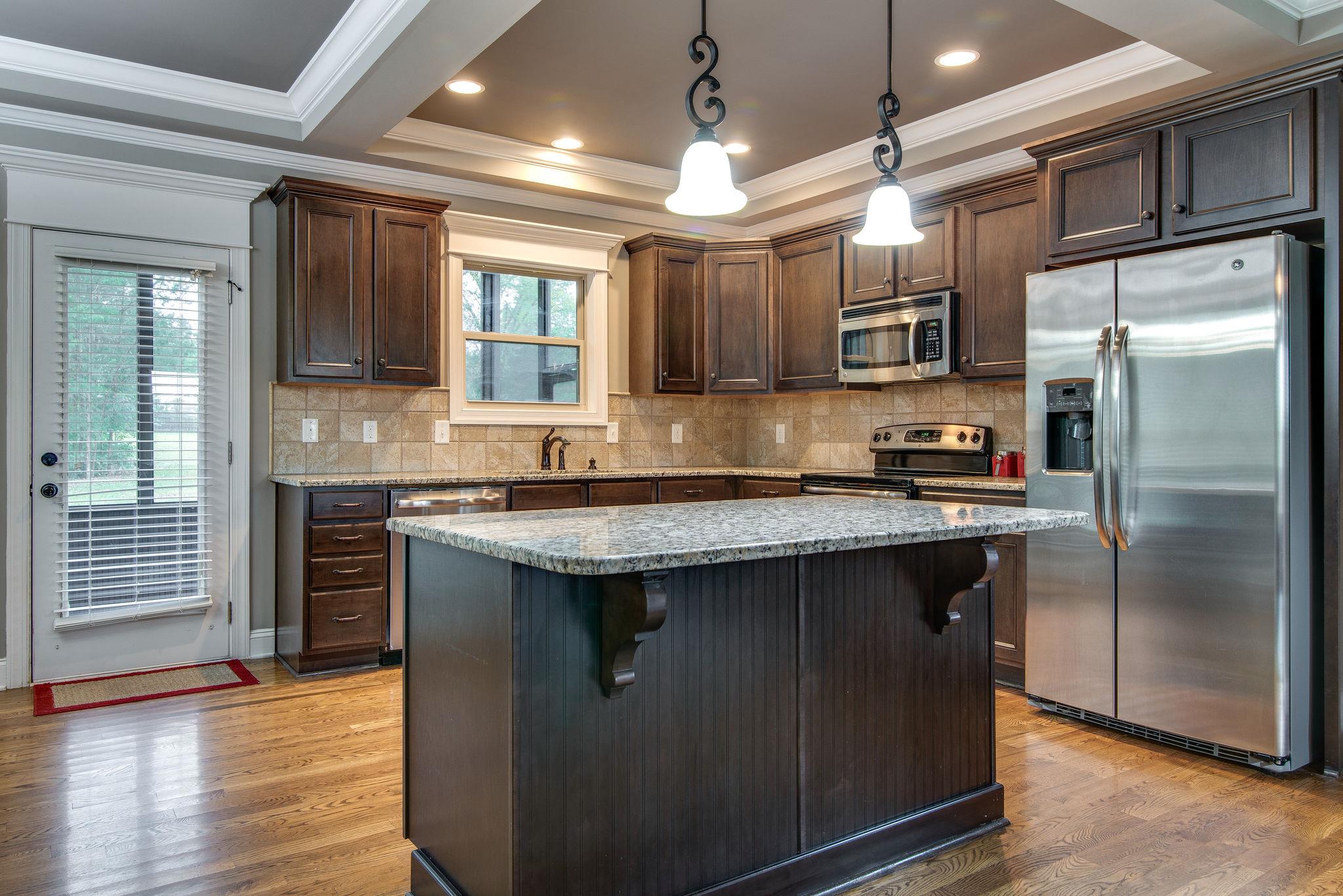 737 Harkreader Road Mount Juliet, TN 37122 - Photo 6 of 26 a kitchen with stainless steel appliances granite countertop a refrigerator a sink and a stove