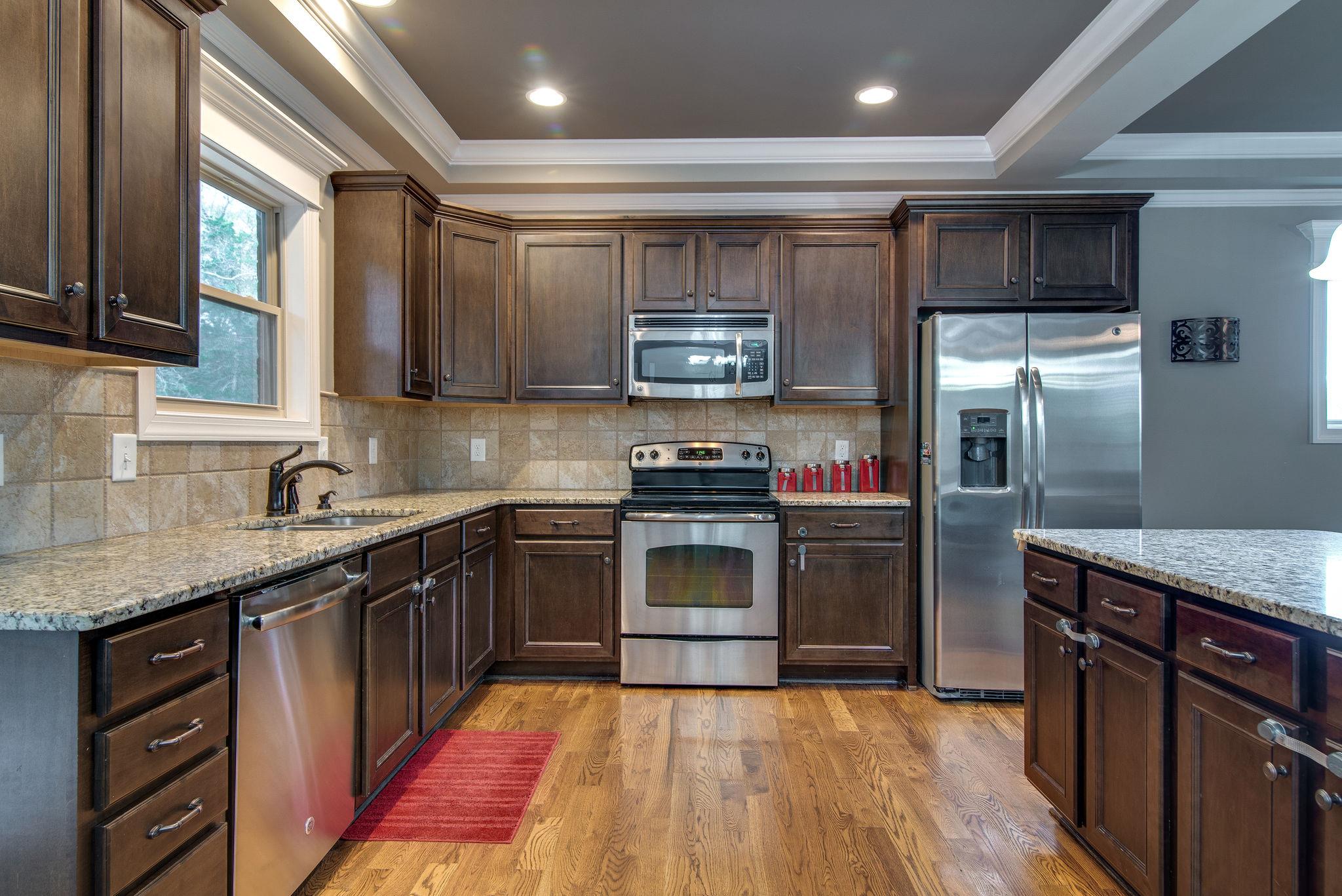 737 Harkreader Road Mount Juliet, TN 37122 - Photo 7 of 26 a kitchen with stainless steel appliances granite countertop a sink stove and refrigerator