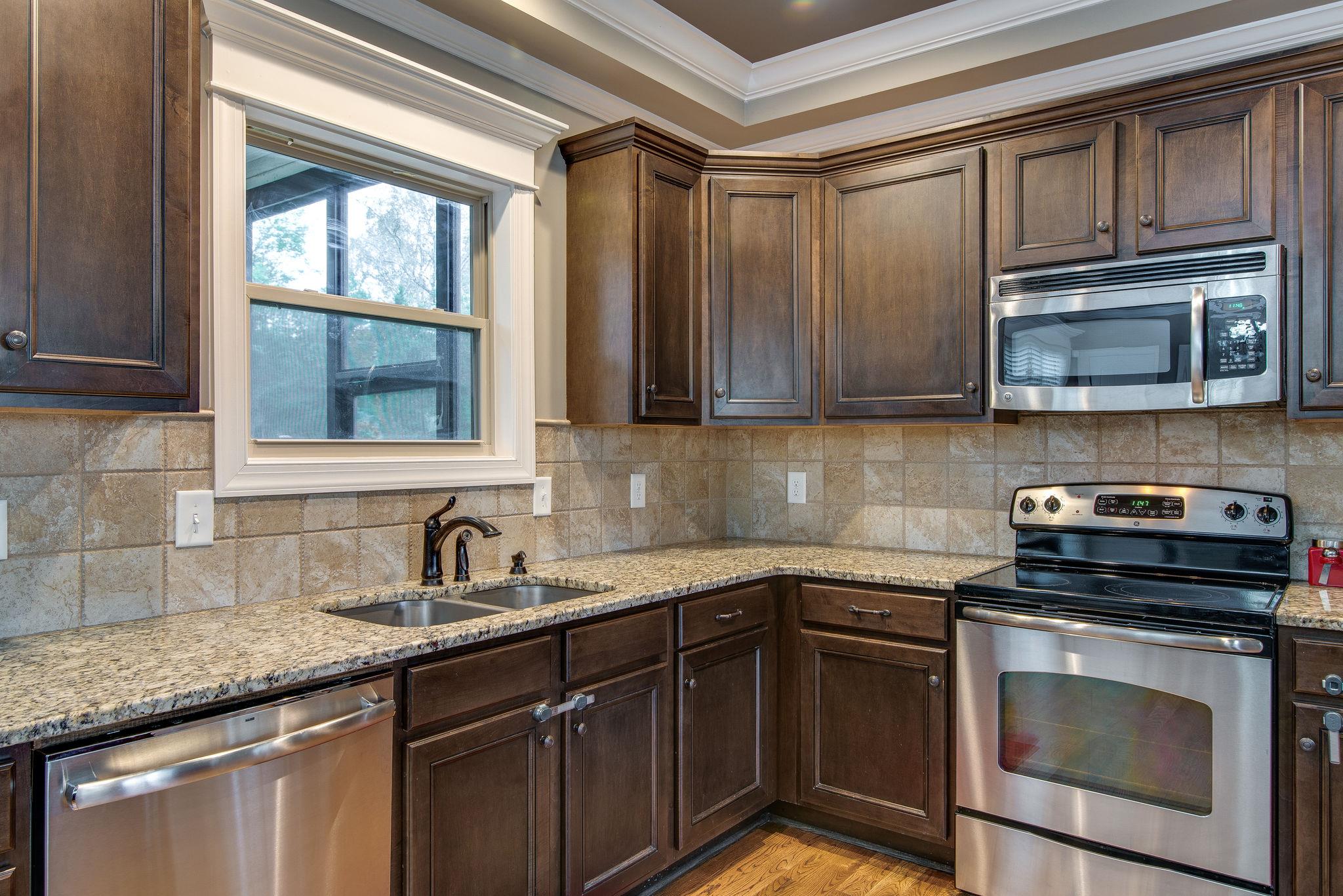 737 Harkreader Road Mount Juliet, TN 37122 - Photo 8 of 26 a kitchen with a sink stove and microwave