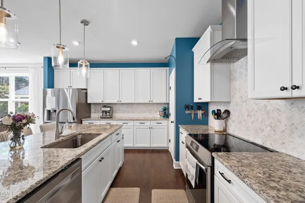 a kitchen with a sink stove and cabinets
