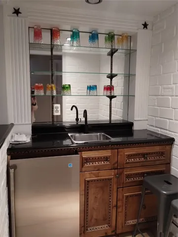 a kitchen with stainless steel appliances granite countertop a sink and cabinets