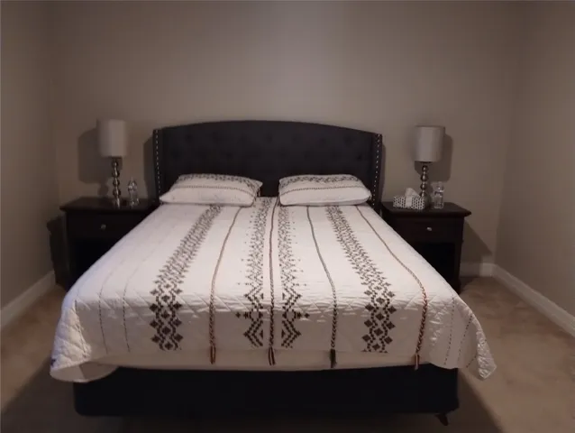 a bedroom with a bed next to a window