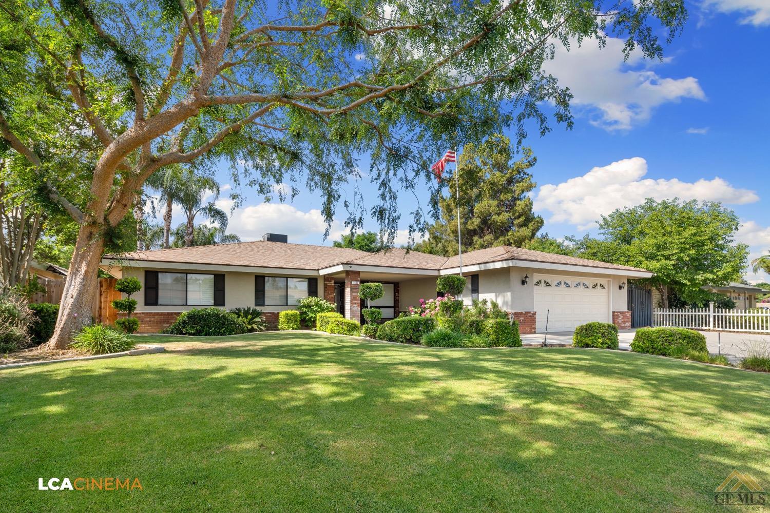 Undisclosed Address Bakersfield, CA 93308 - Photo 2 of 23 a front view of a house with a garden