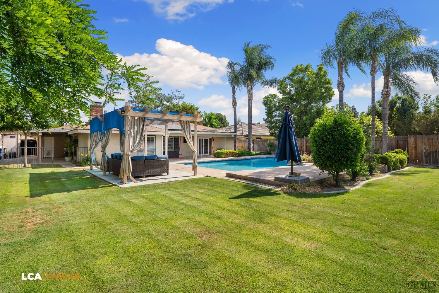 Undisclosed Address Bakersfield, CA 93308 - Photo 22 of 23 a view of a house with swimming pool and a small yard