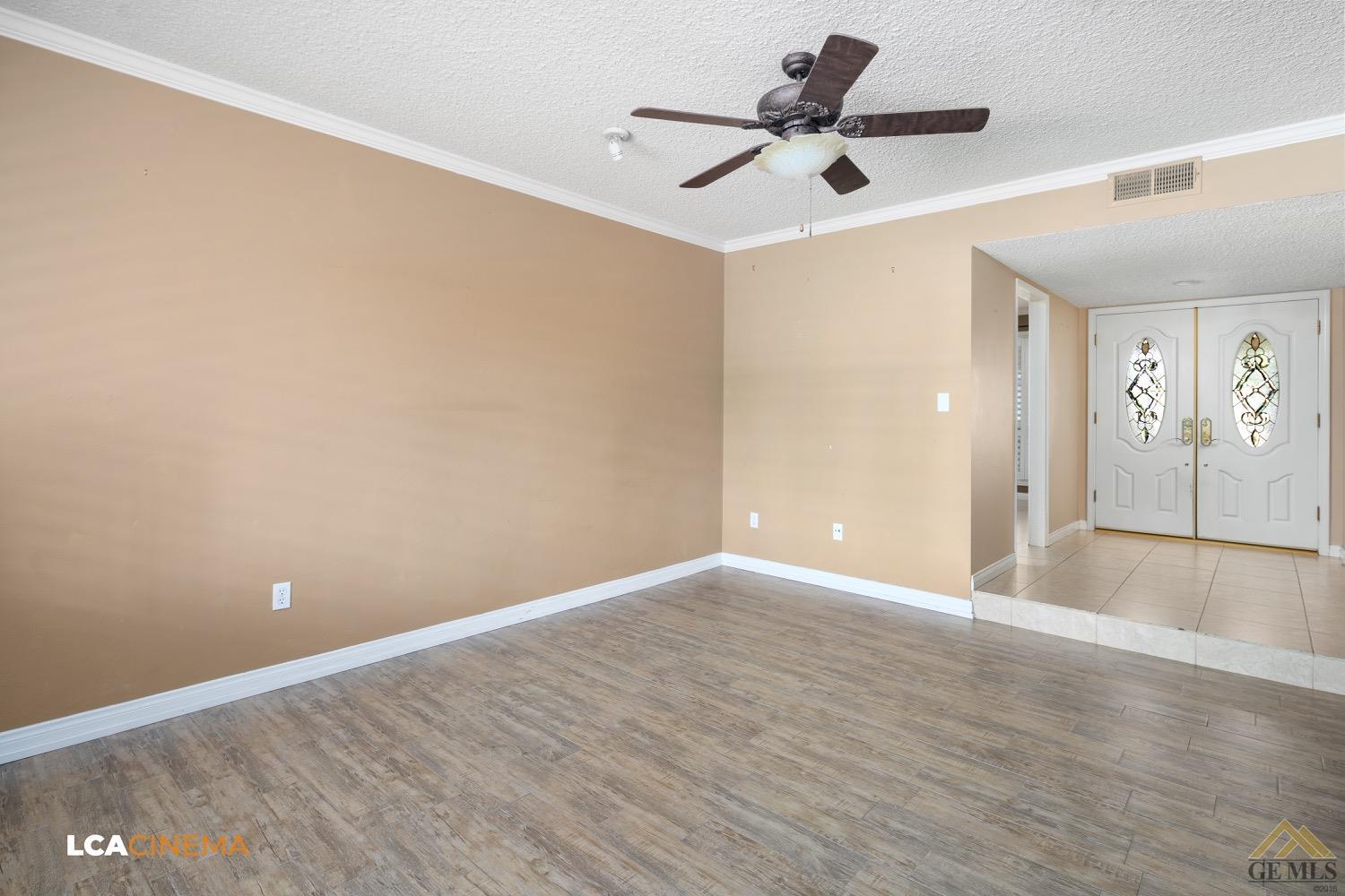 Undisclosed Address Bakersfield, CA 93308 - Photo 5 of 23 a view of a room with wooden floor and a ceiling fan