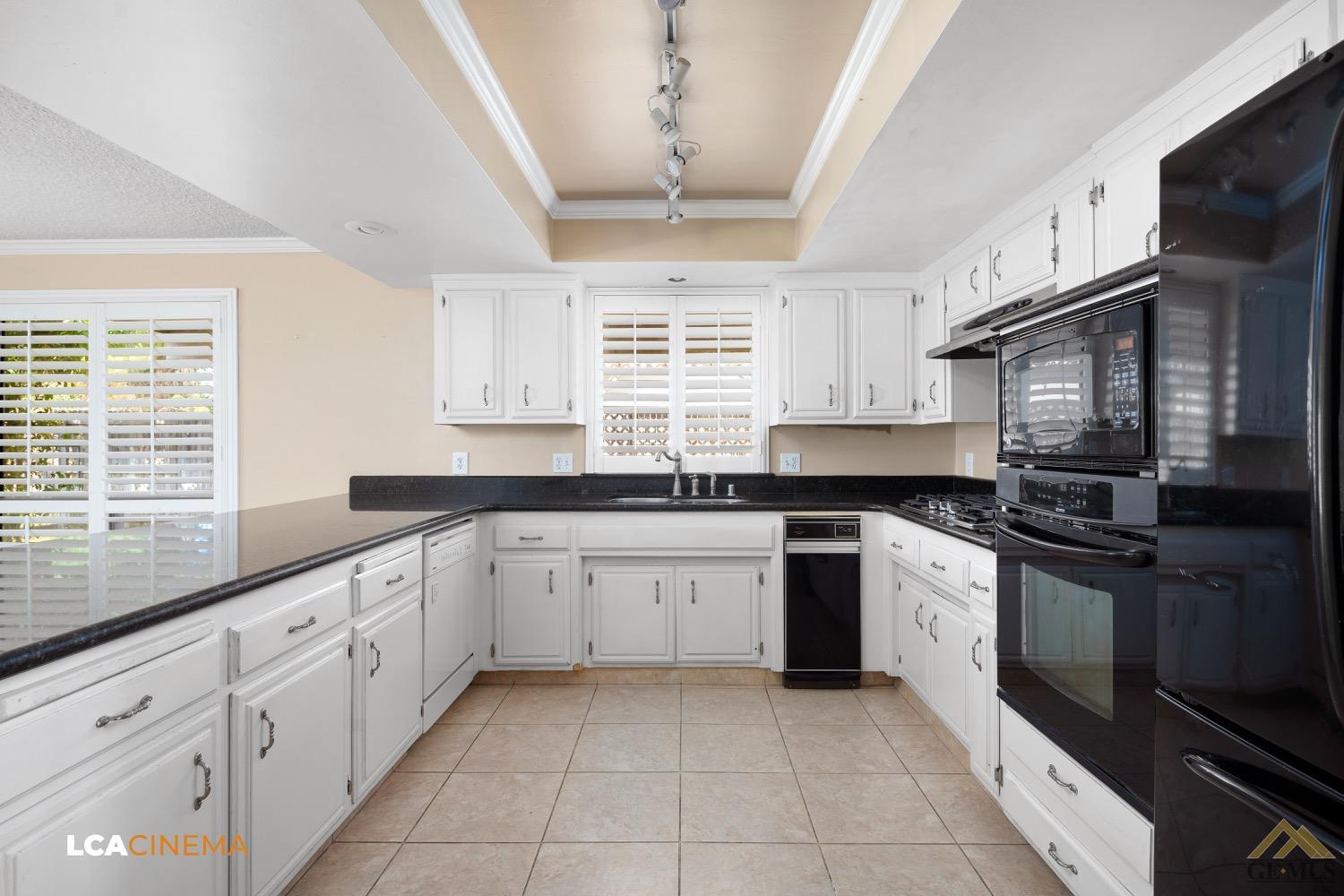 Undisclosed Address Bakersfield, CA 93308 - Photo 9 of 23 a kitchen with granite countertop cabinets stainless steel appliances a sink and a window
