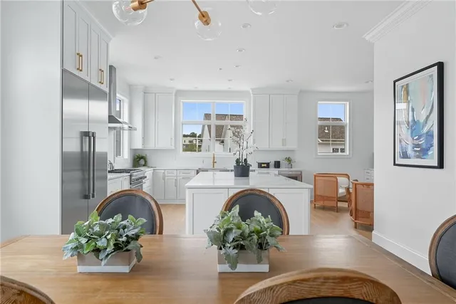 a dining room with furniture a chandelier and wooden floor