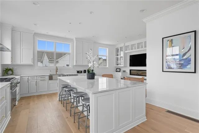 a kitchen with kitchen island granite countertop a sink stove and refrigerator