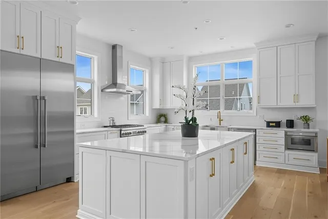 a kitchen with stainless steel appliances a refrigerator sink and stove