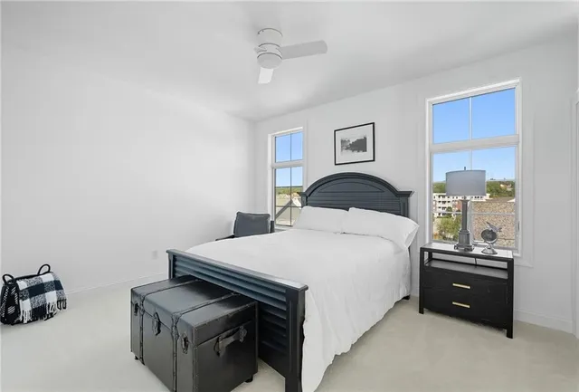 a bathroom with a granite countertop sink a toilet and mirror
