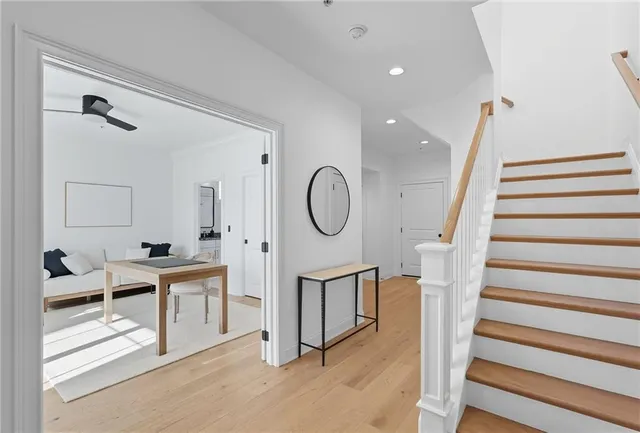 a very nice looking room with wooden floor and white walls