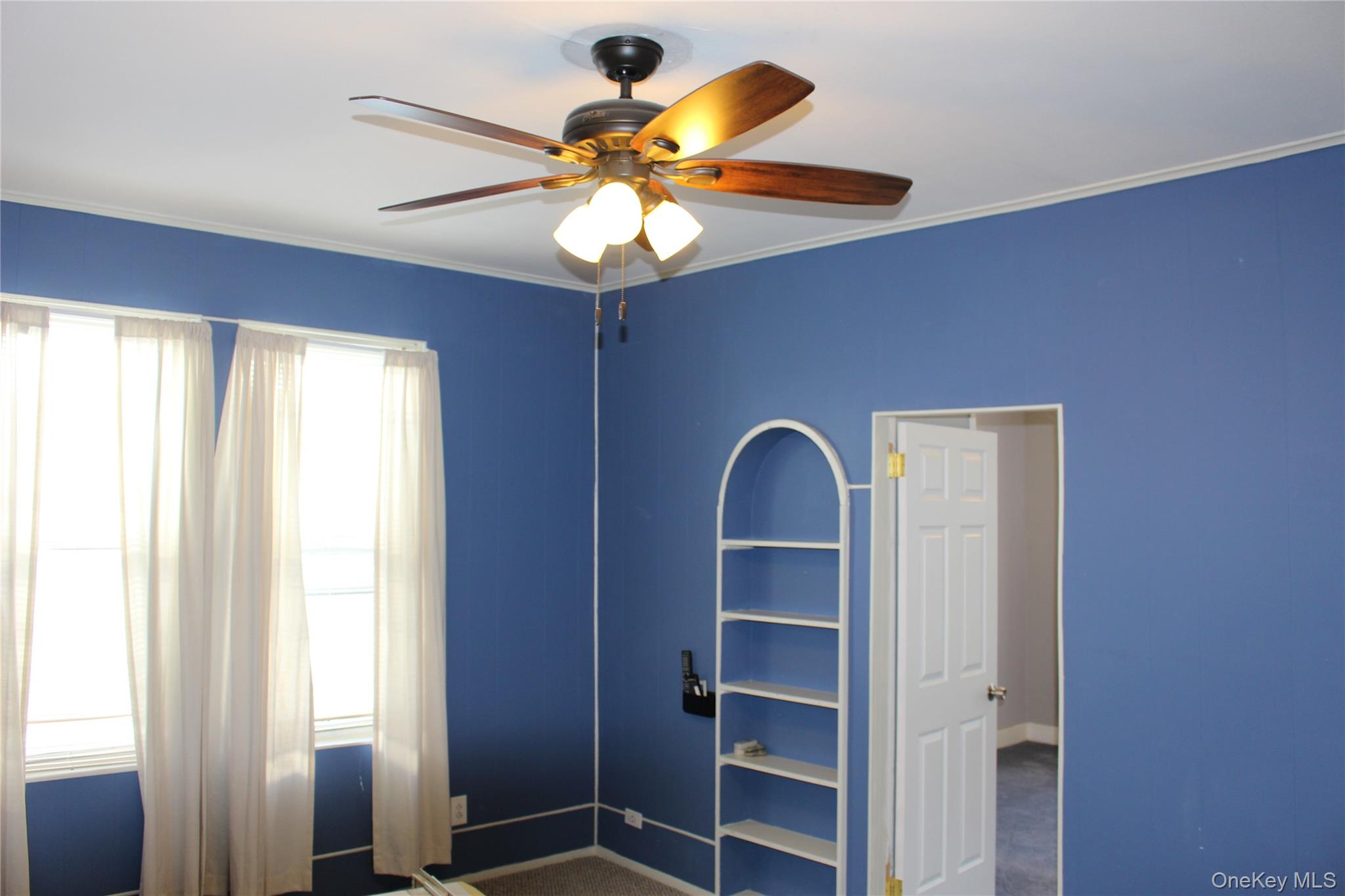 2973 Harding Avenue Bronx, NY 10465 - Photo 18 of 27 Unfurnished bedroom featuring crown molding, ceiling fan, and dark colored carpet