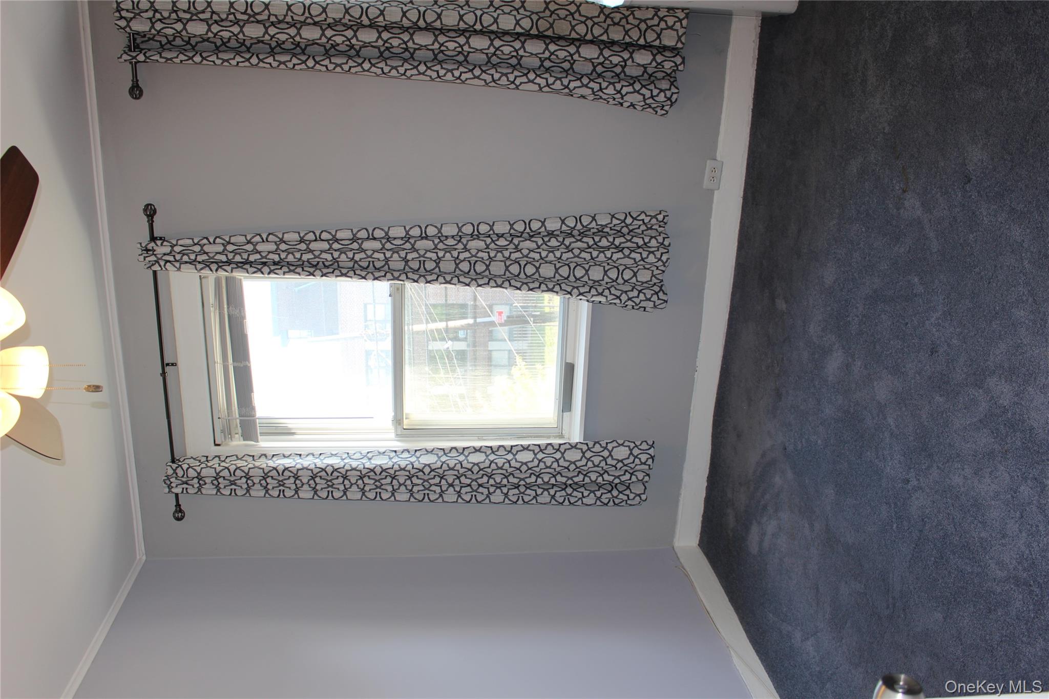 2973 Harding Avenue Bronx, NY 10465 - Photo 21 of 27 Spare room with a ceiling fan, crown molding, and dark carpet