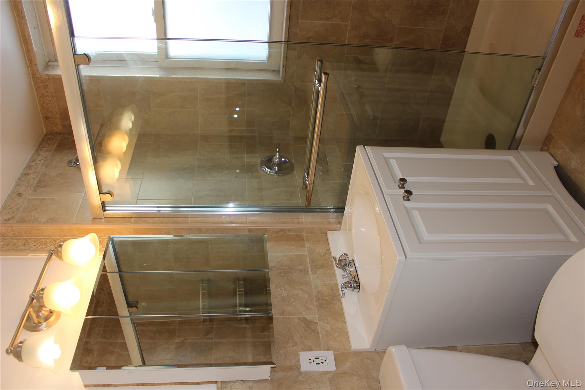 2973 Harding Avenue Bronx, NY 10465 - Photo 22 of 27 Full bath featuring tile walls, vanity, and a shower stall