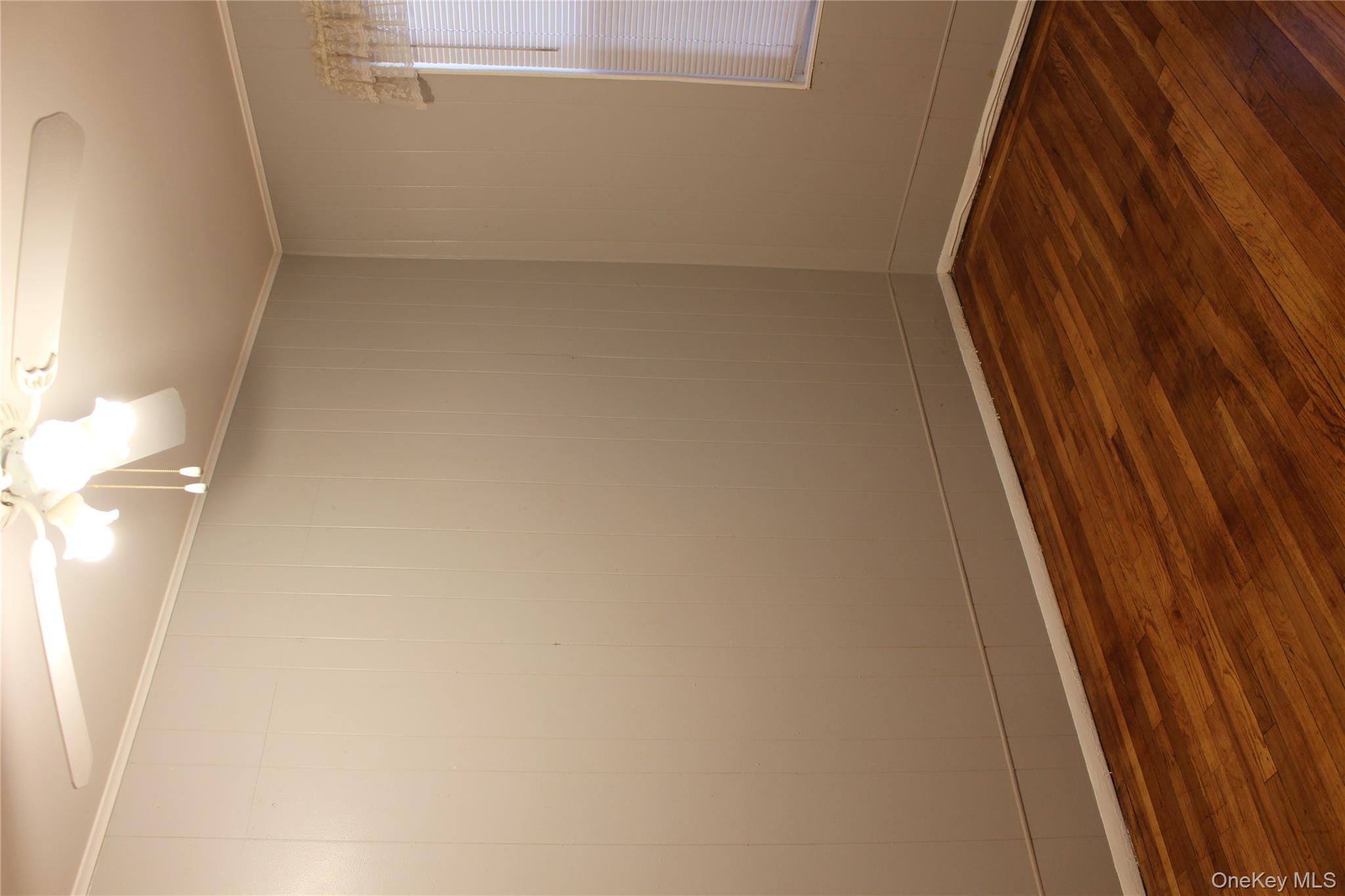 2973 Harding Avenue Bronx, NY 10465 - Photo 23 of 27 Unfurnished room with dark wood-type flooring, a ceiling fan, and crown molding