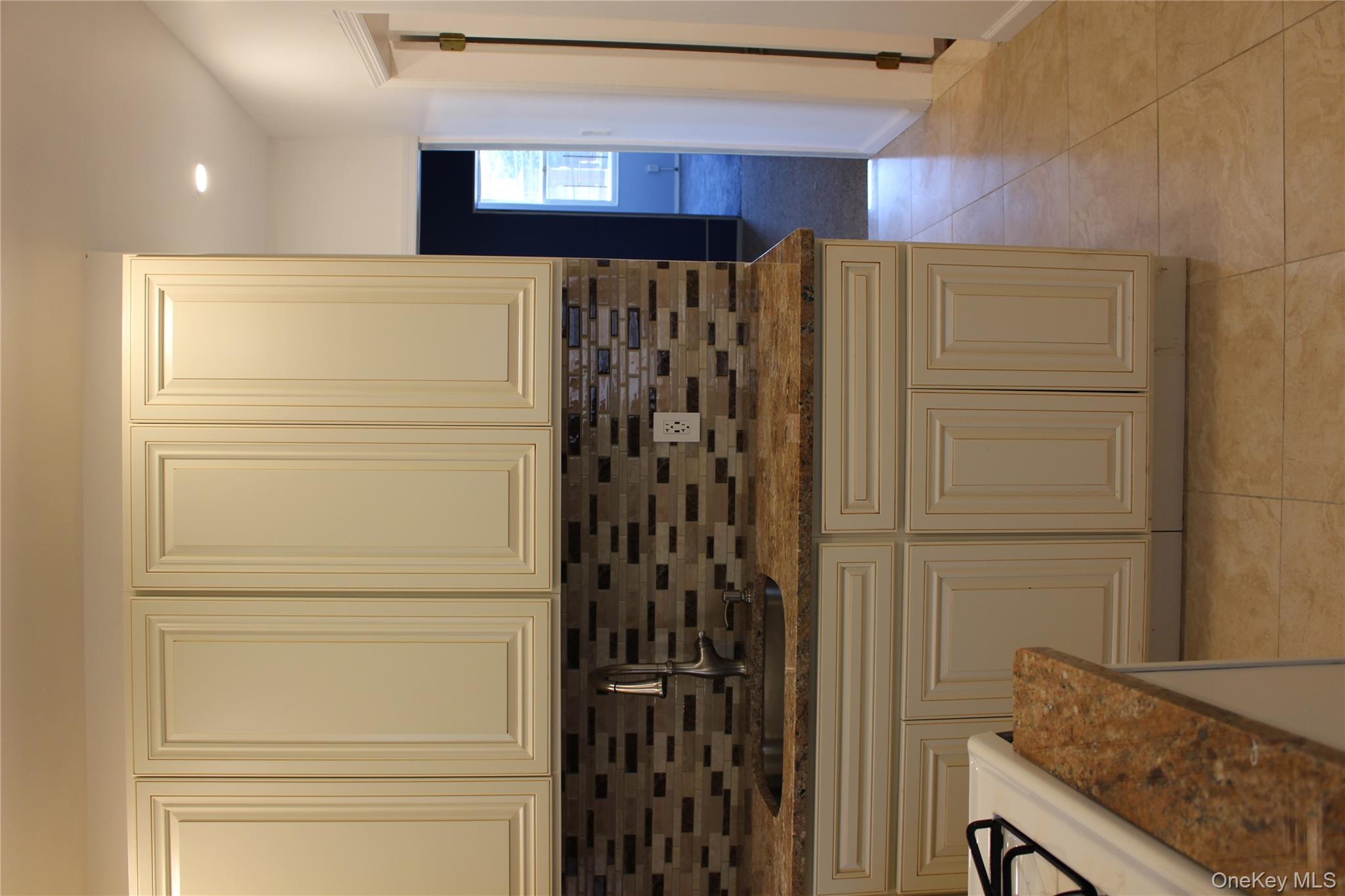 2973 Harding Avenue Bronx, NY 10465 - Photo 26 of 27 Kitchen with tasteful backsplash, dark stone countertops, light tile patterned floors, and recessed lighting