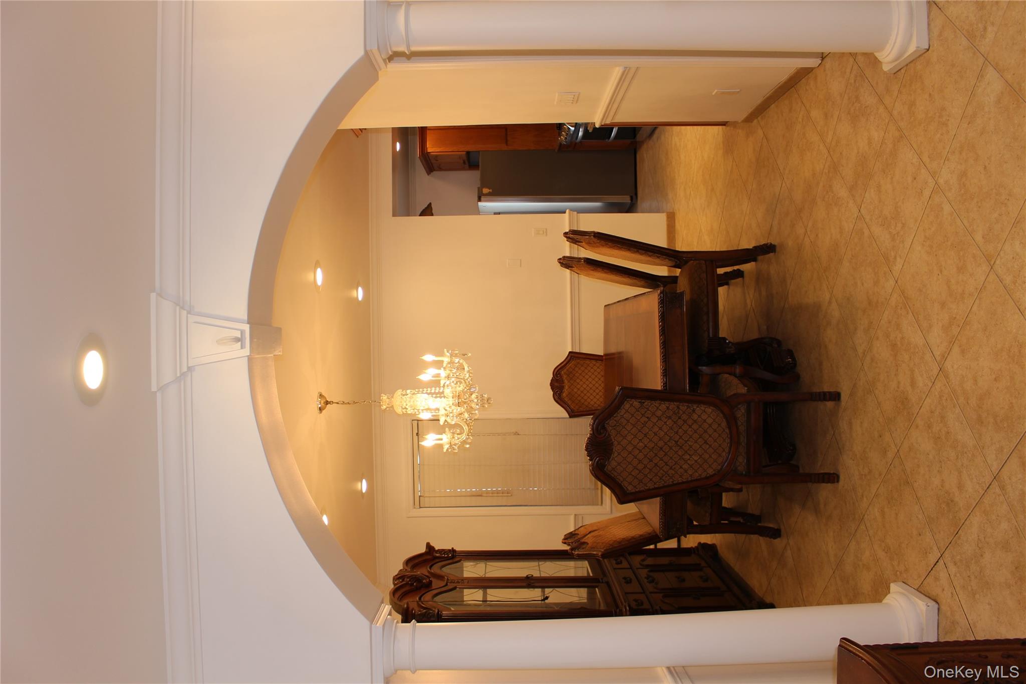 2973 Harding Avenue Bronx, NY 10465 - Photo 6 of 27 Dining room featuring arched walkways, ornate columns, crown molding, a chandelier, and recessed lighting