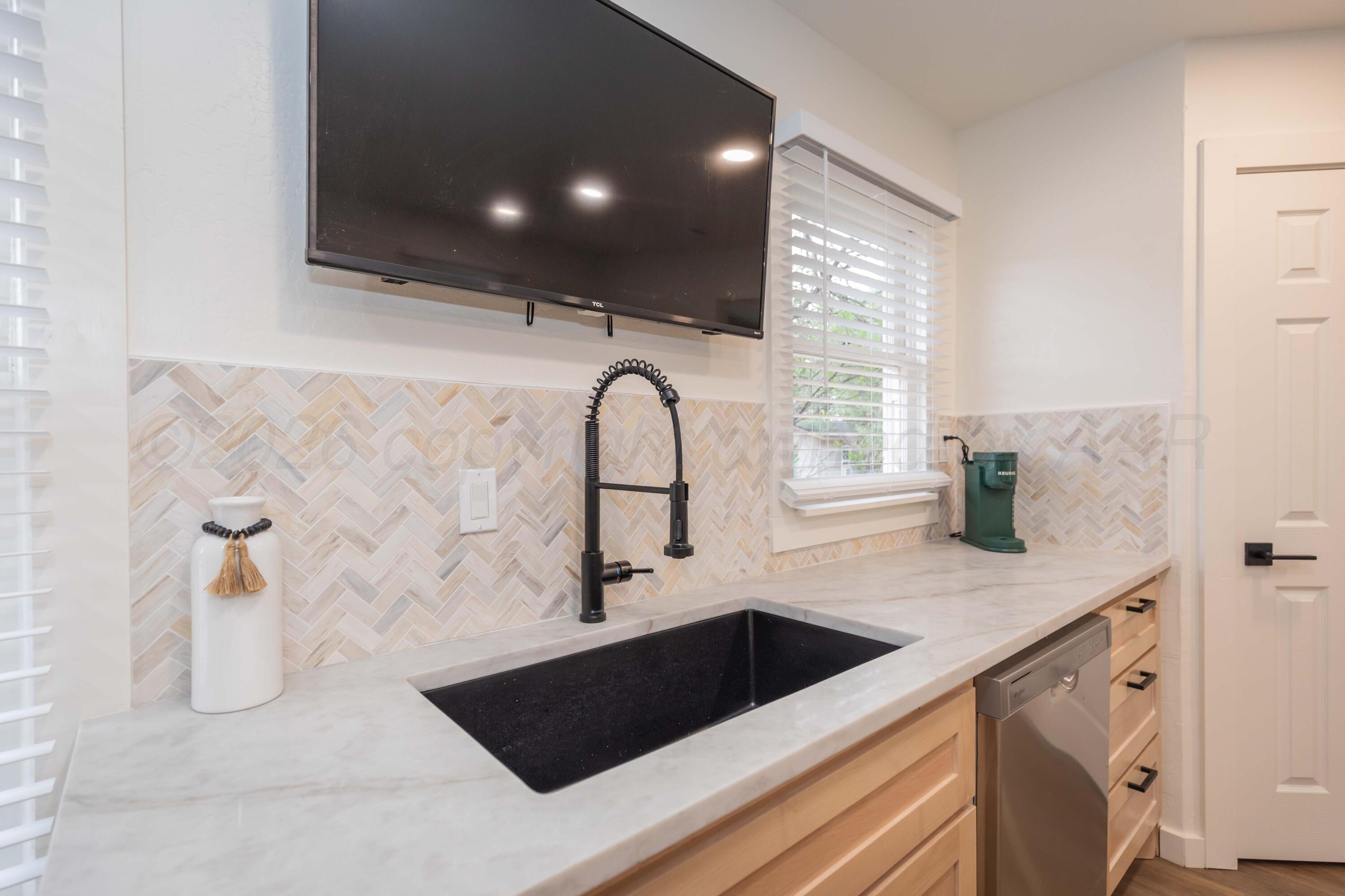 504 High Street Claude, TX 79019 - Photo 23 of 39 a kitchen with a sink and a stove top oven