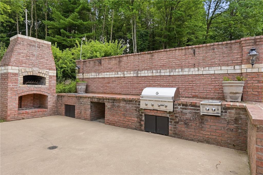 809 Franklin Road Mars, PA 16046 - Photo 34 of 44 Built-in brick outdoor kitchen with wood-burning fireplace, grill, dual burners and sink